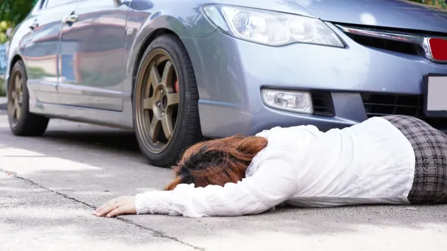 Injured person laying on the road after getting injured in a pedestrian accident in Orlando, Florida